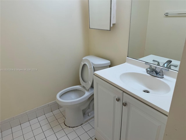 bathroom featuring toilet, tile patterned flooring, and vanity