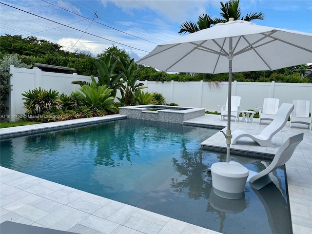 view of swimming pool featuring an in ground hot tub and a patio