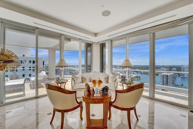 dining space with light tile patterned flooring and a water view