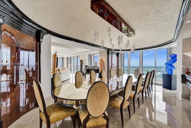 dining space with floor to ceiling windows and a water view