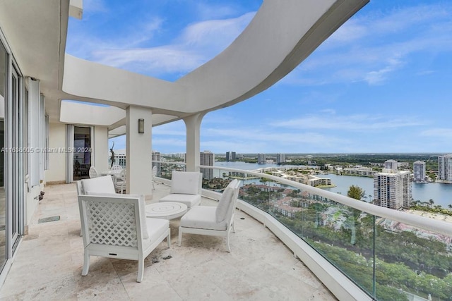 view of patio featuring a water view and a balcony