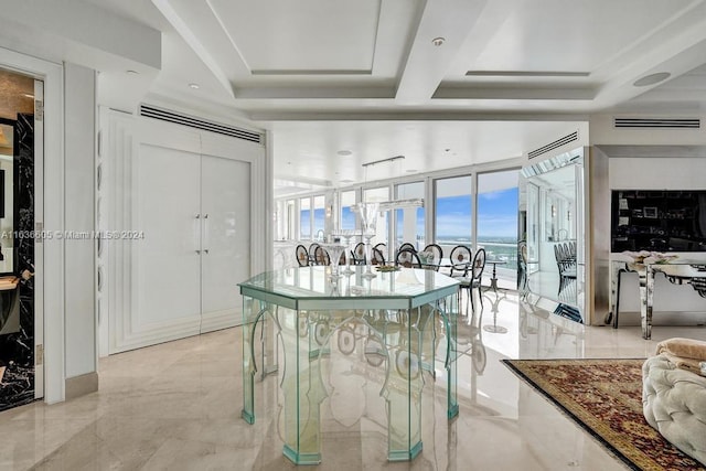 interior space with light tile patterned flooring and a tray ceiling