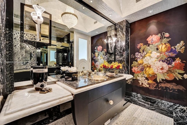 bathroom with vanity, a raised ceiling, and tile patterned floors