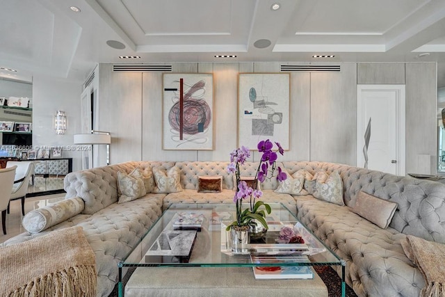 living room featuring a raised ceiling