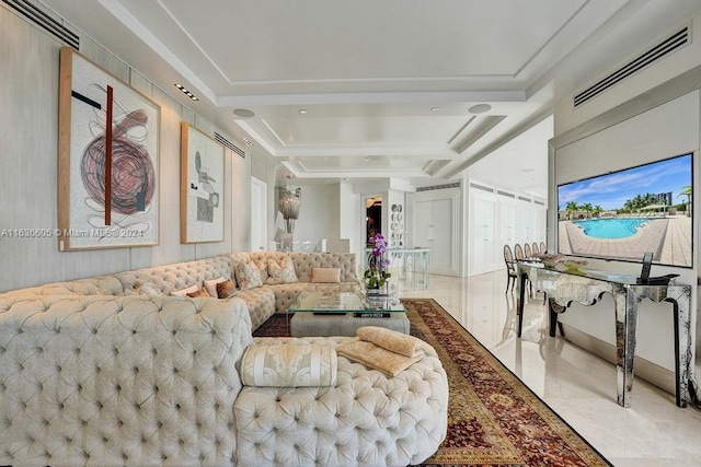 tiled living room featuring a tray ceiling