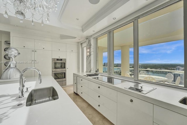 kitchen featuring sink, white cabinetry, a tray ceiling, black electric cooktop, and stainless steel double oven