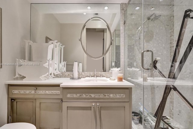 bathroom with walk in shower and vanity