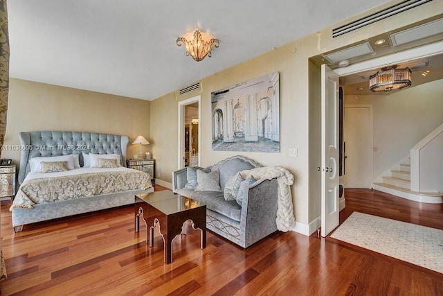 bedroom with hardwood / wood-style flooring