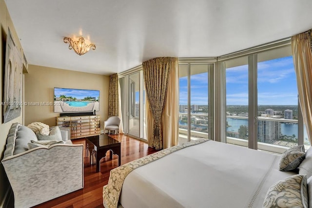 bedroom featuring dark hardwood / wood-style flooring and access to outside