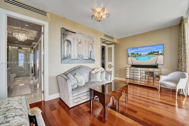 interior space featuring hardwood / wood-style flooring and an inviting chandelier