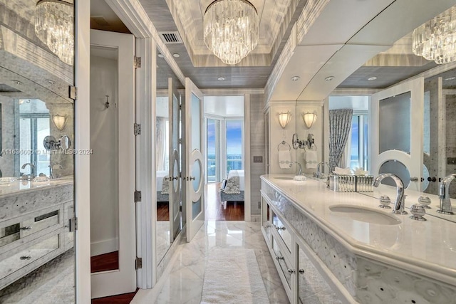 bathroom with a notable chandelier, tile patterned floors, double vanity, crown molding, and french doors