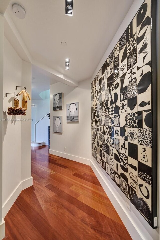 hall with hardwood / wood-style floors