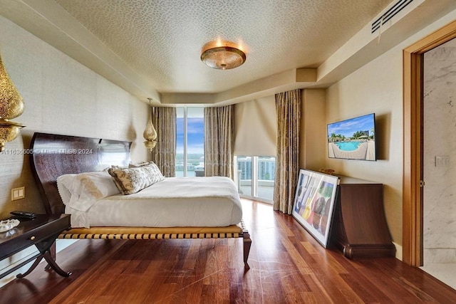 bedroom featuring a textured ceiling and hardwood / wood-style flooring