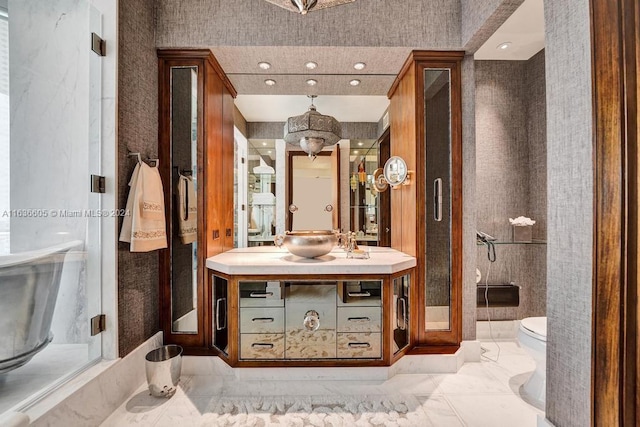 bathroom featuring walk in shower, vanity, and toilet