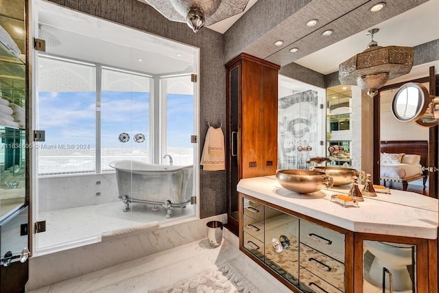 bathroom featuring vanity and a tub to relax in