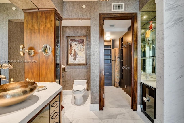 bathroom with tile patterned flooring, toilet, and vanity