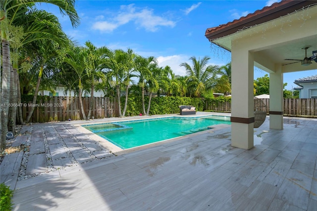 view of swimming pool featuring a patio and ceiling fan