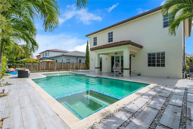 view of swimming pool with an in ground hot tub, a patio area, and ceiling fan