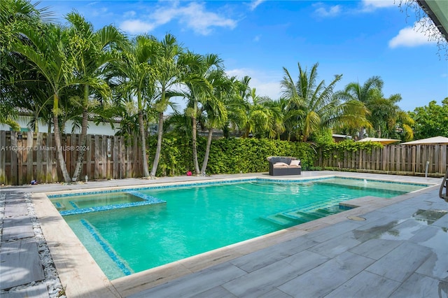 view of swimming pool with an in ground hot tub and a patio