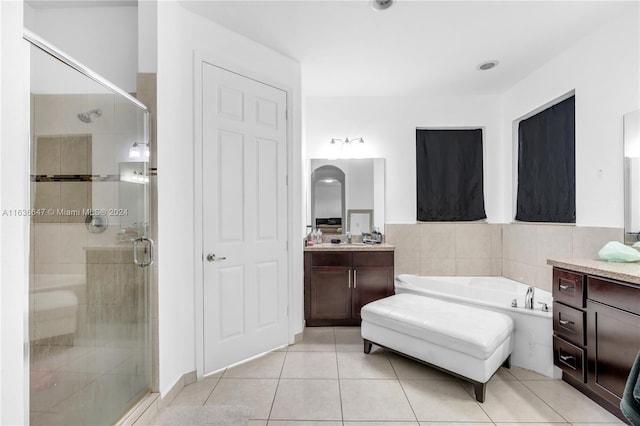 bathroom featuring vanity, plus walk in shower, and tile patterned floors