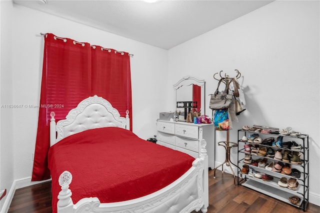 bedroom with dark hardwood / wood-style floors