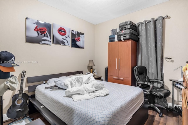 bedroom with hardwood / wood-style floors