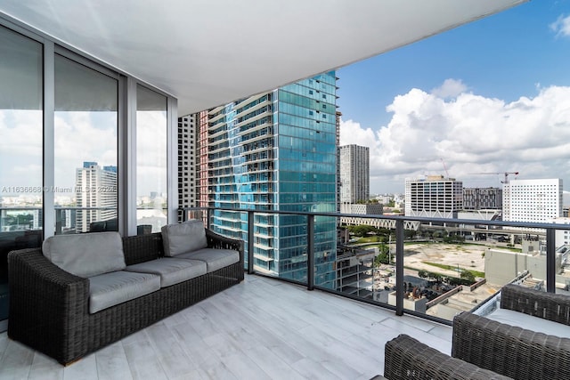 balcony featuring a city view and outdoor lounge area