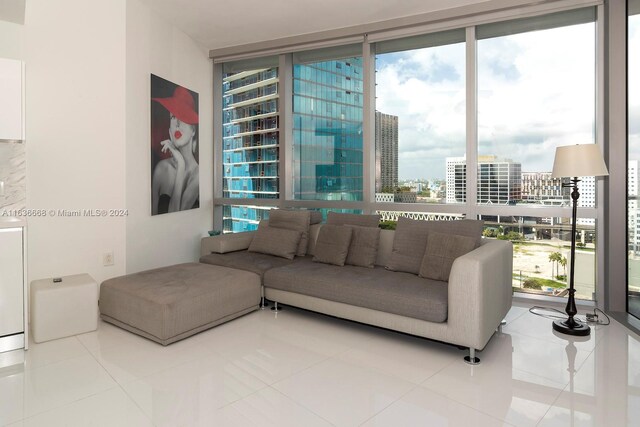 living room featuring tile patterned floors, expansive windows, and plenty of natural light