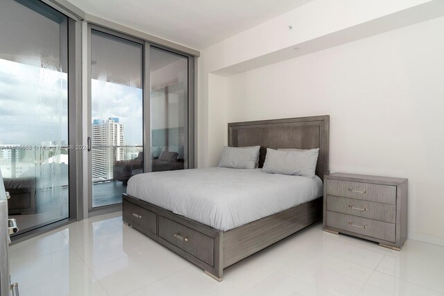 tiled bedroom with access to outside and expansive windows