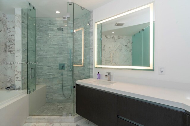 bathroom featuring tile patterned flooring, a shower with shower door, and vanity