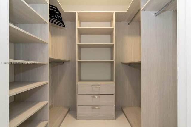 spacious closet with light tile patterned floors