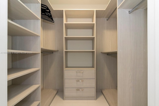 spacious closet with light tile patterned flooring