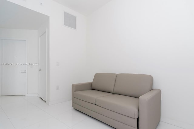 sitting room with light tile patterned floors, visible vents, and baseboards