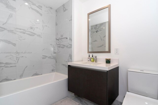 full bathroom with vanity, tile patterned flooring, tiled shower / bath, and toilet