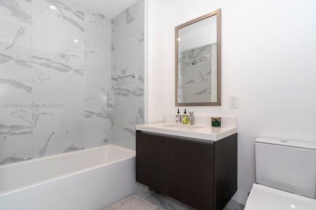 bathroom featuring toilet, marble finish floor,  shower combination, and vanity