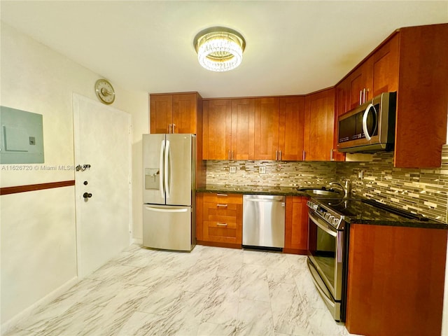 kitchen with stainless steel appliances, backsplash, light tile patterned floors, electric panel, and dark stone countertops