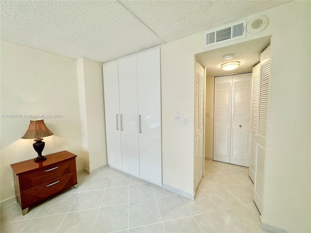 tiled bedroom featuring a closet