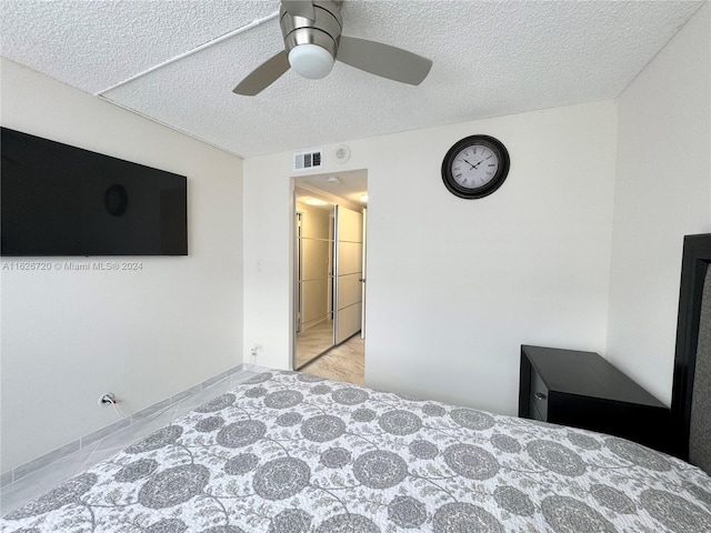 bedroom featuring a textured ceiling and ceiling fan