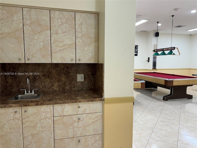 interior space featuring light tile patterned floors, hanging light fixtures, billiards, and sink