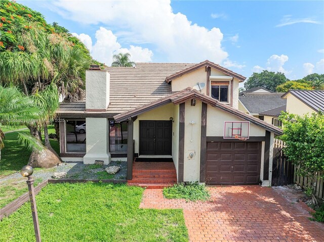 view of front of home featuring a garage and a front yard