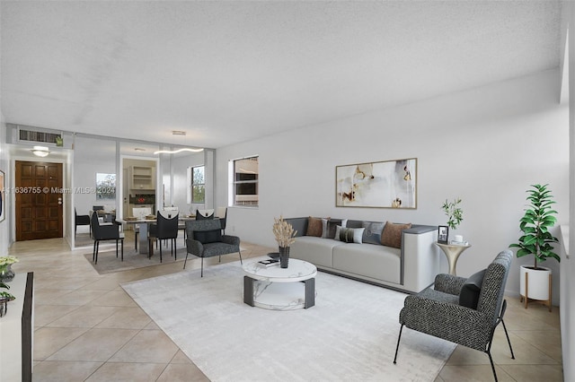 tiled living room featuring a textured ceiling