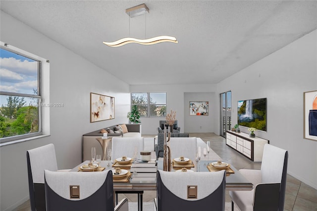 tiled dining area featuring a textured ceiling