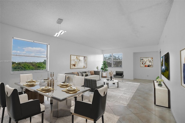 tiled dining room with a textured ceiling