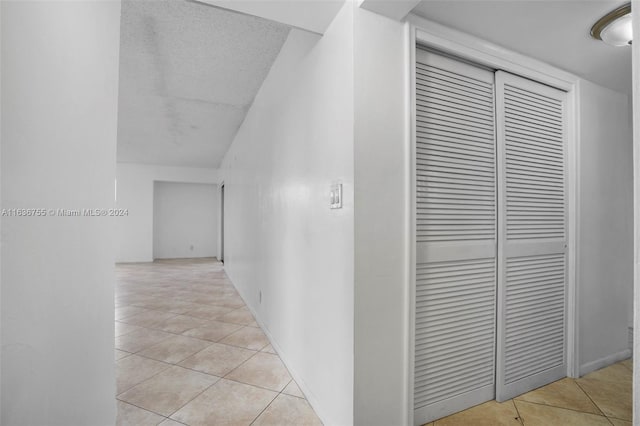 hall featuring light tile patterned floors