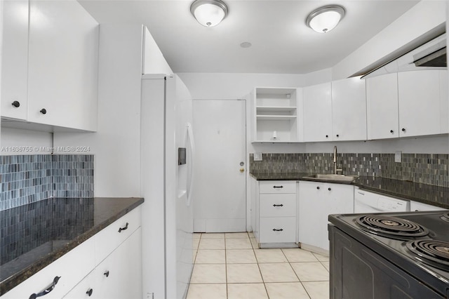 kitchen featuring sink, white cabinetry, white refrigerator with ice dispenser, and light tile patterned floors