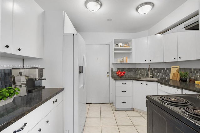 kitchen with tasteful backsplash, white cabinets, light tile patterned floors, sink, and white fridge with ice dispenser