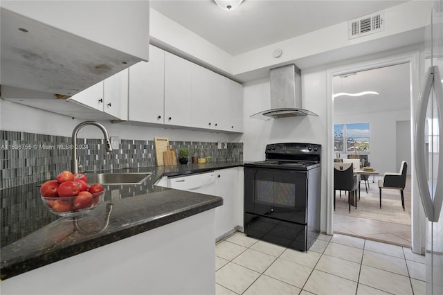 kitchen featuring black range with electric stovetop, dark stone counters, wall chimney exhaust hood, tasteful backsplash, and sink