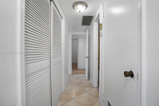 hall featuring light tile patterned floors