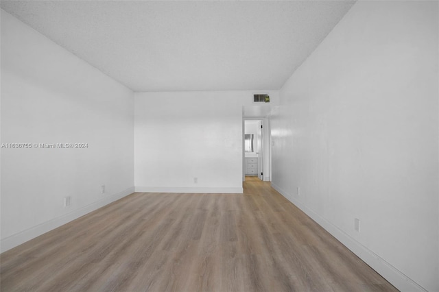 empty room with hardwood / wood-style flooring