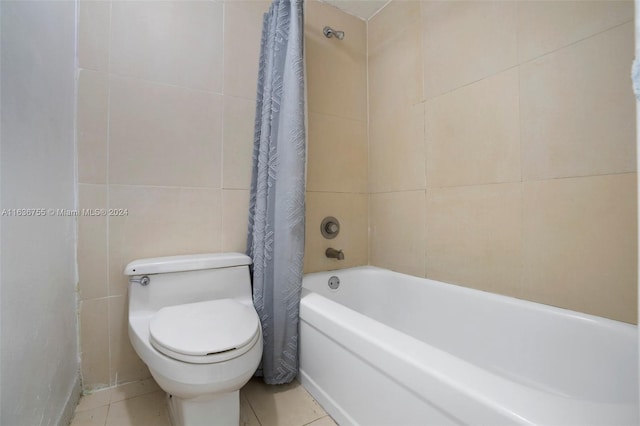 bathroom with tile patterned flooring, shower / bath combination with curtain, and toilet